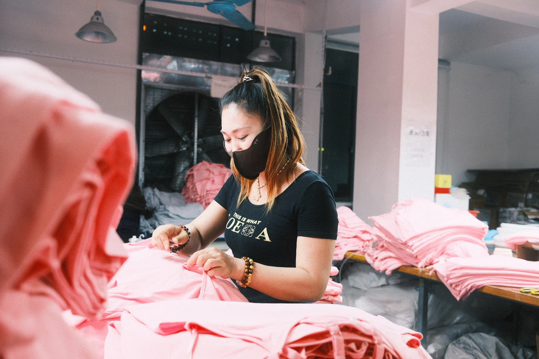 Blesstop team member inspecting garment quality