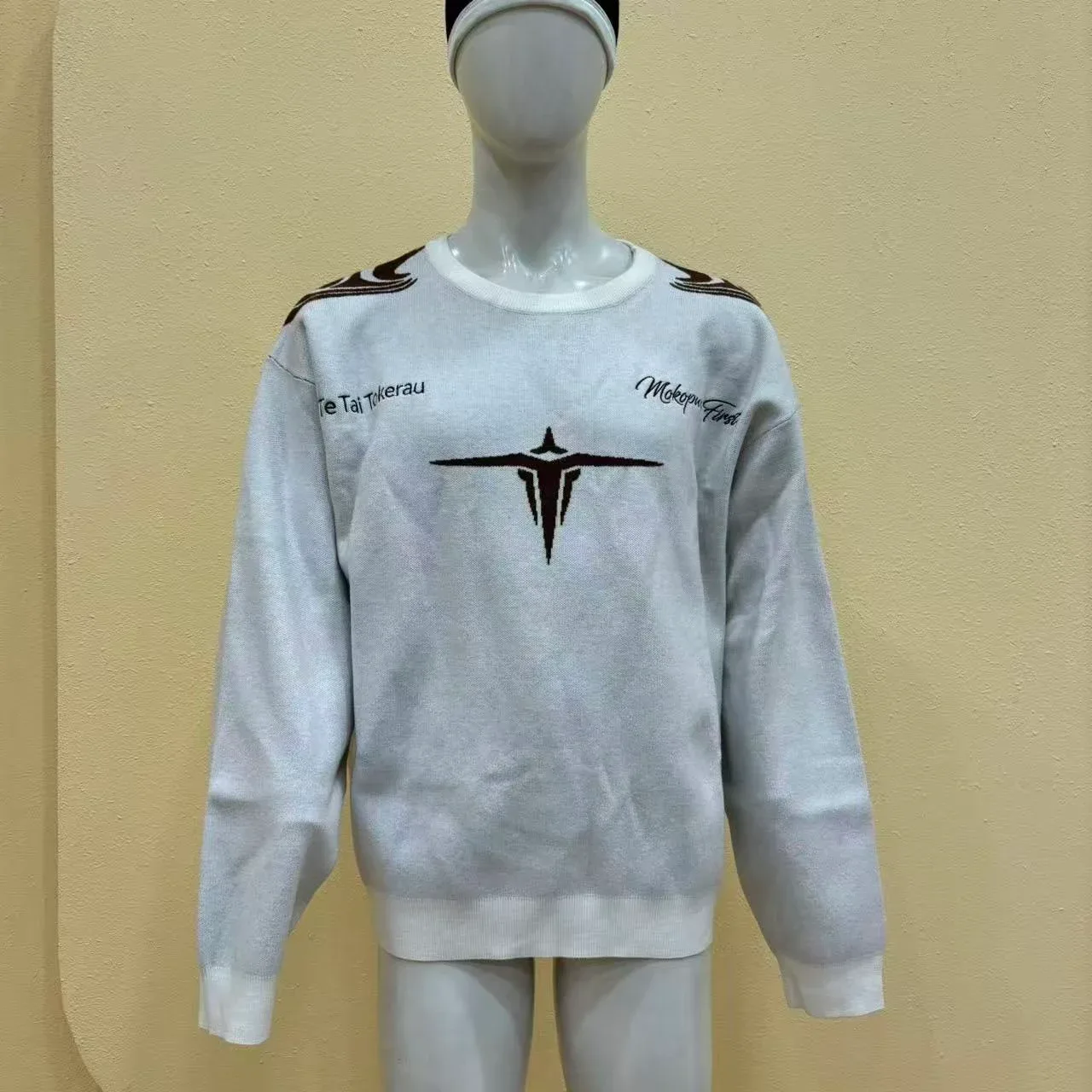 Initial light-coloured jacquard knit pre-production sample on a mannequin