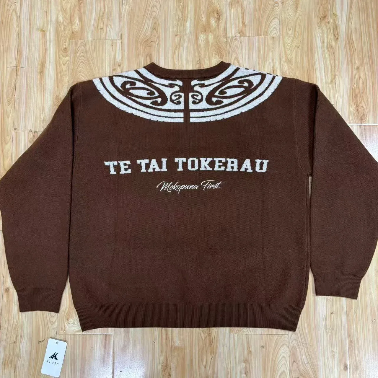 Back of the brown jacquard knit sweater showing shoulder pattern and corrected garment wording